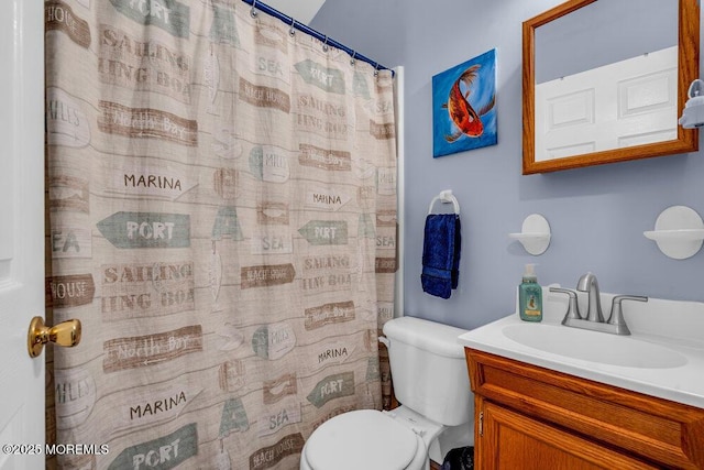 bathroom with vanity, curtained shower, and toilet