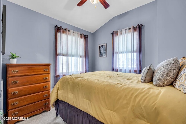 carpeted bedroom with vaulted ceiling and ceiling fan