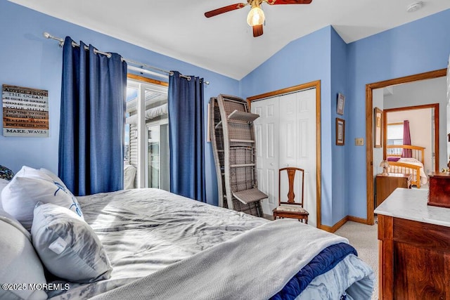 carpeted bedroom with ceiling fan, vaulted ceiling, and a closet