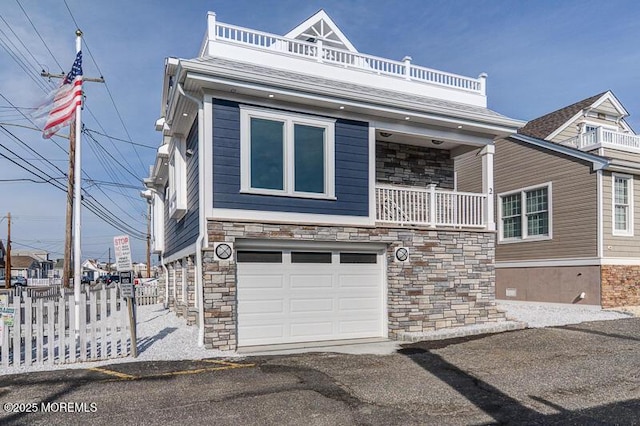 view of front of house with a garage and a balcony