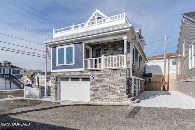 view of front of house featuring a garage and a balcony