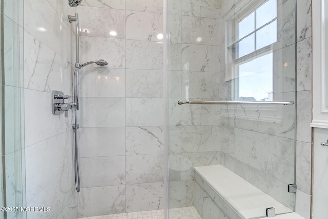 bathroom with an enclosed shower and a wealth of natural light