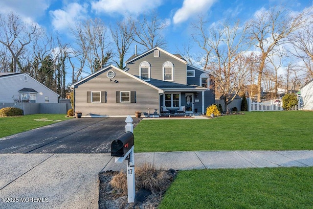 front of property with covered porch and a front lawn