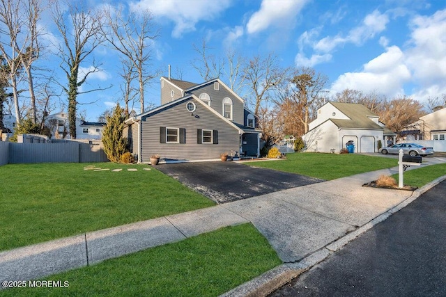 view of front of property featuring a garage and a front lawn