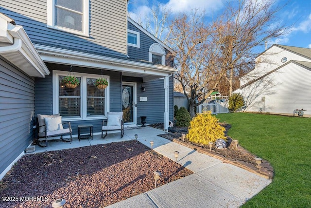 doorway to property with a lawn