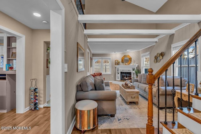 living room with beamed ceiling and light wood-type flooring