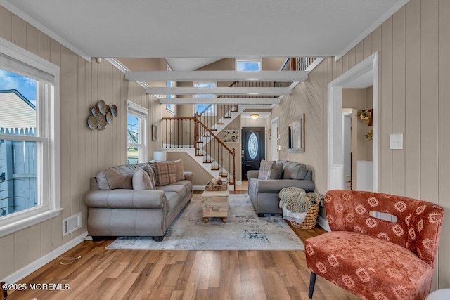 living room with crown molding and light hardwood / wood-style floors