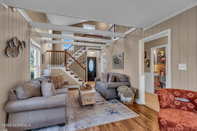 living room featuring wood-type flooring and vaulted ceiling