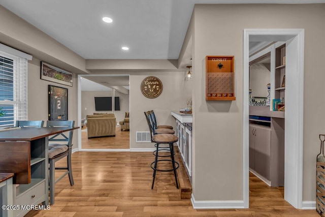 interior space featuring a kitchen breakfast bar and light wood-type flooring