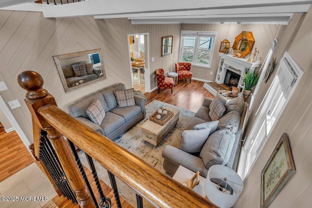 living room featuring beam ceiling and light hardwood / wood-style floors