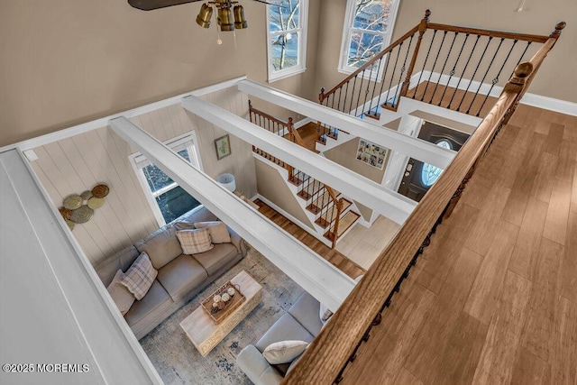 stairs featuring hardwood / wood-style floors and ceiling fan