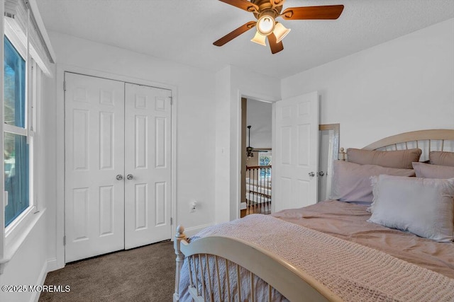 bedroom featuring carpet floors, a textured ceiling, ceiling fan, and a closet