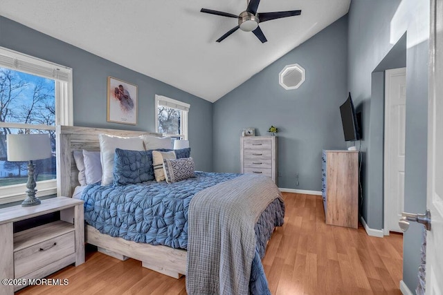 bedroom featuring ceiling fan, lofted ceiling, and light wood-type flooring