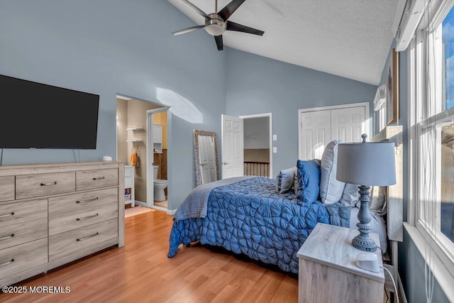 bedroom with ensuite bath, light hardwood / wood-style flooring, a textured ceiling, a closet, and ceiling fan