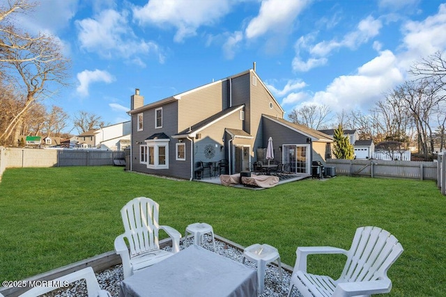 back of house with a lawn and a patio area