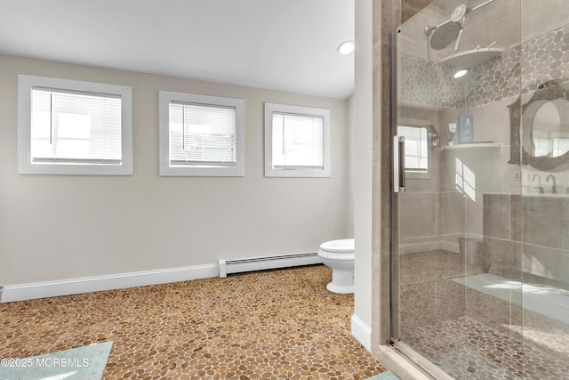 bathroom with a shower with door, a baseboard radiator, and toilet