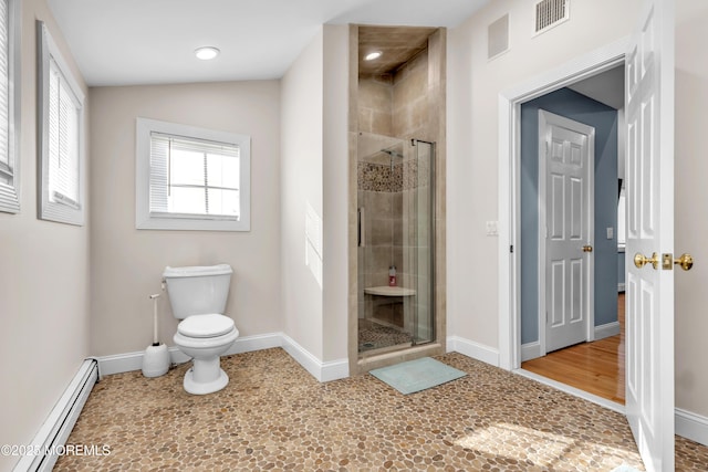 bathroom featuring a shower with door, vaulted ceiling, baseboard heating, and toilet