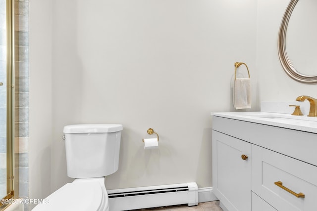 bathroom with vanity, toilet, and baseboard heating