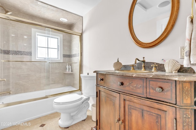 full bathroom with vanity, toilet, tile patterned flooring, and combined bath / shower with glass door