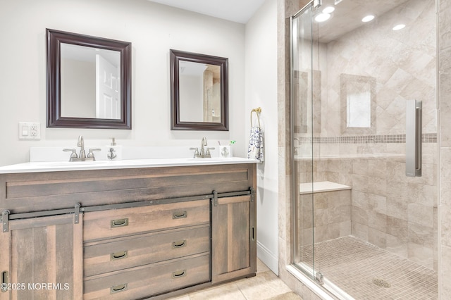 bathroom featuring tile patterned flooring, vanity, and a shower with shower door