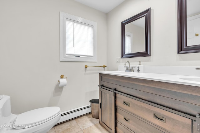 bathroom with tile patterned flooring, vanity, baseboard heating, and toilet