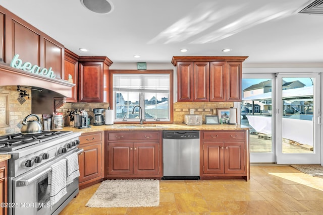 kitchen featuring tasteful backsplash, appliances with stainless steel finishes, and sink