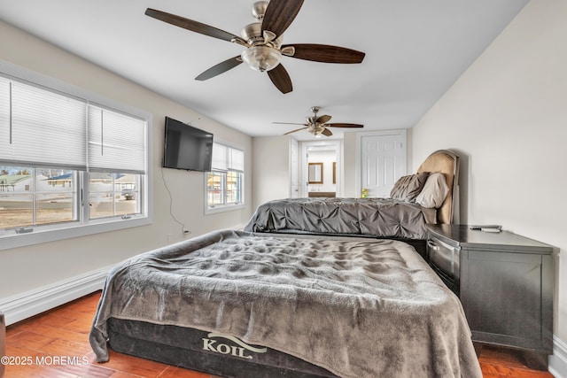 bedroom featuring wood-type flooring, ceiling fan, and baseboard heating