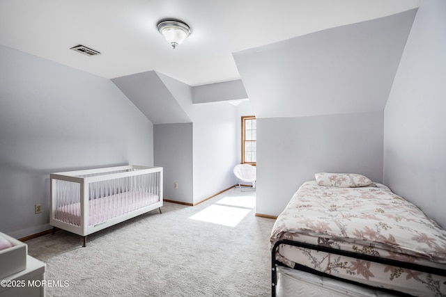 bedroom featuring baseboards, visible vents, vaulted ceiling, and light colored carpet