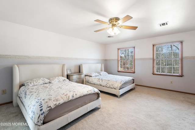 bedroom with light colored carpet, visible vents, and baseboards