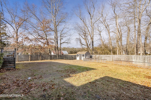 view of yard with a fenced backyard, a storage unit, and an outdoor structure