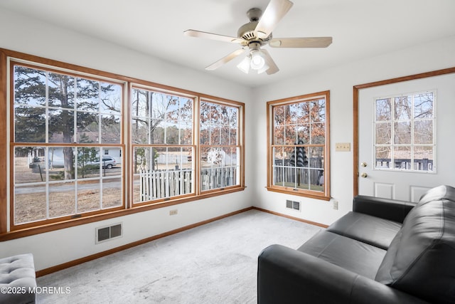 sunroom featuring plenty of natural light, visible vents, and a ceiling fan