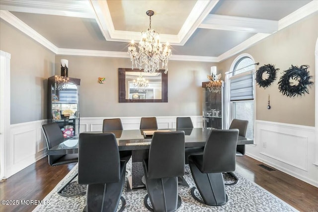 dining room featuring crown molding, dark hardwood / wood-style floors, and a chandelier