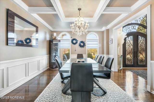 dining room featuring crown molding, dark wood-type flooring, a notable chandelier, and french doors