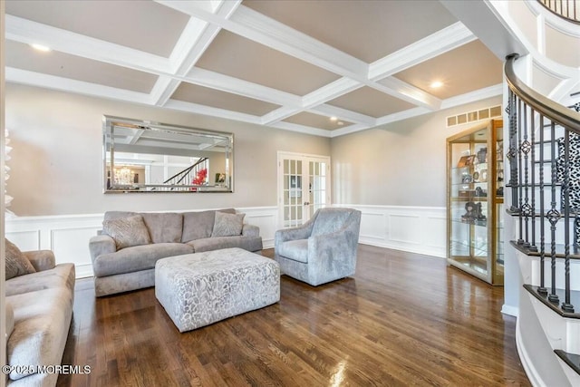 living room featuring beamed ceiling, dark wood-type flooring, and french doors