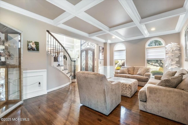 living room featuring dark hardwood / wood-style flooring, beam ceiling, ornamental molding, and coffered ceiling