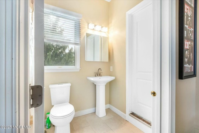 bathroom featuring toilet and tile patterned flooring