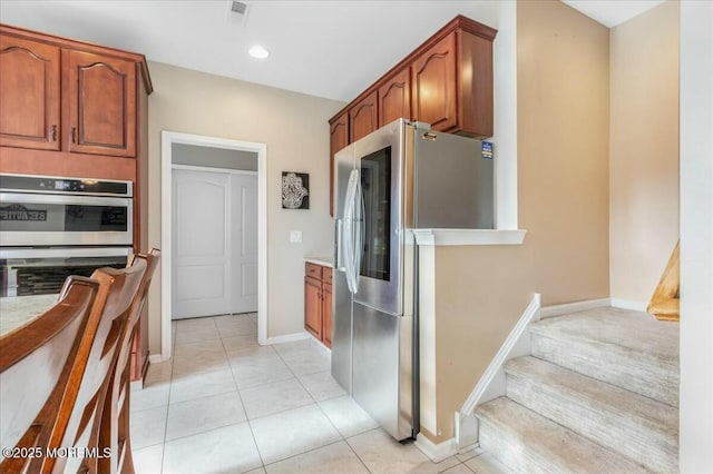 kitchen featuring light tile patterned floors and stainless steel appliances