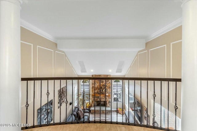 hallway with ornamental molding and hardwood / wood-style floors