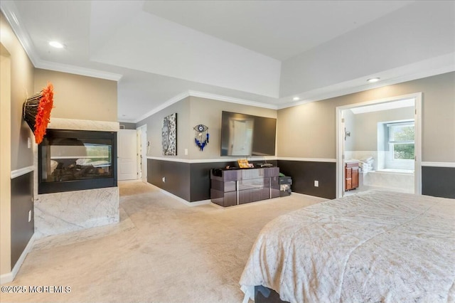 bedroom featuring a tray ceiling, crown molding, light colored carpet, and a multi sided fireplace