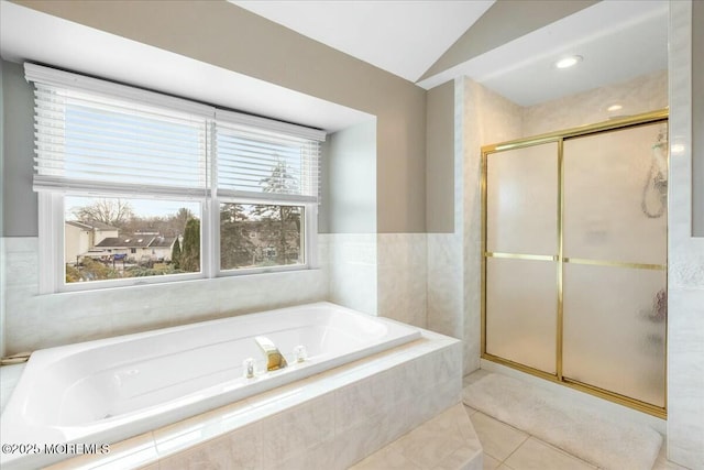 bathroom with lofted ceiling, tile patterned flooring, and separate shower and tub