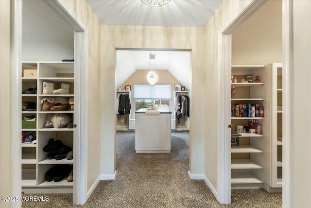 corridor featuring vaulted ceiling and carpet floors