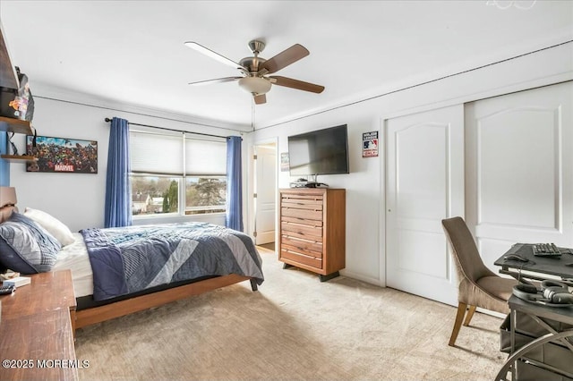 bedroom featuring ceiling fan, a closet, and light carpet