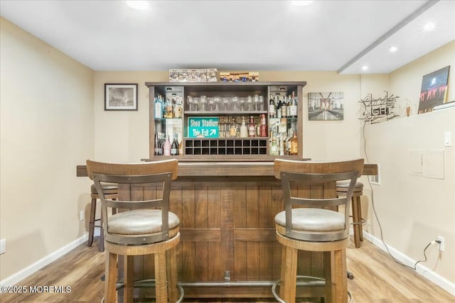 bar with hardwood / wood-style floors