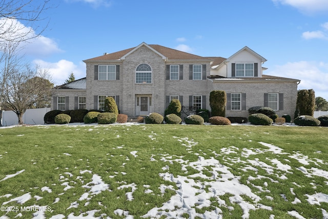 colonial-style house featuring a lawn