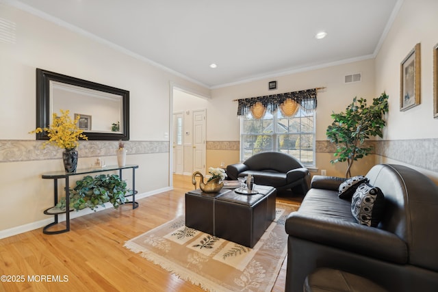 living room featuring hardwood / wood-style flooring and ornamental molding