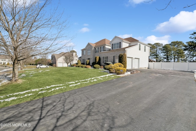 view of front of home featuring a garage and a front lawn