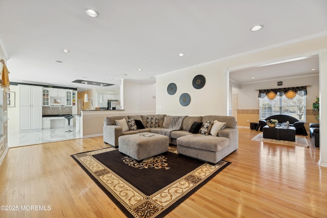 living room featuring crown molding and hardwood / wood-style flooring