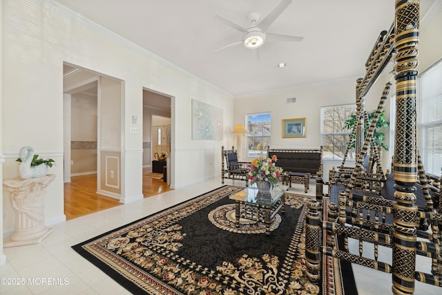 living room with ceiling fan, ornamental molding, and light tile patterned floors