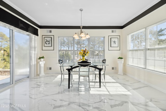 dining room with a notable chandelier and crown molding