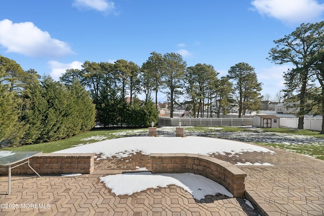 view of swimming pool featuring a storage shed